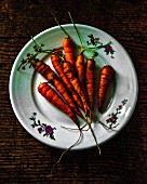 Fresh carrots on a vintage plate