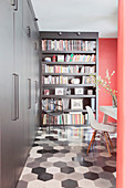 Grey fitted cupboards in study with honeycomb tiled floor