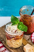 Spaghetti with roasted tomato sauce and parmesan in a glass jar