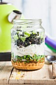 Thai style DIY instant soup with peanut and chilli paste, peas, glass noodles, spring onions and brussels sprouts in a glass jar (Vegan)