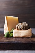 Cheese and fruit on wooden cutting board