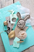 Easter mood board: fabric rabbit, gilt stone and paper