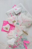 Translucent origami hearts with confetti on printed paper