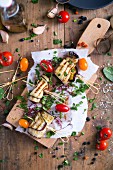Grilled Aubergine with tomatoes and chives on a cutting board