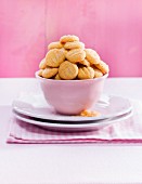 A pile of butter biscuits in a pink bowl