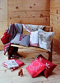 Alpine-style cushions and accessories on wooden bench
