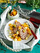 Grilled pork cutlet with a pineapple, orange and pepper salsa
