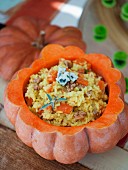 Pumpkin risotto with walnuts served in a hollowed out pumpkin