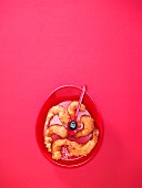 Fried shrimps on a red plate against a pink background (Valentine's Day)