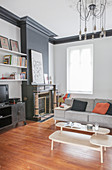 Coffee table sofa and fireplace in living room in shades of grey