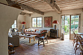 Wood-beamed ceiling, tiled floor and terrace doors in rustic living room