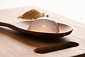 Raindrop cake on a wooden spoon (close up)