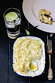 Fish pie with hard boiled eggs in an enamel dish