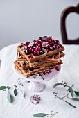 Belgian spelt waffles with warm cherries, cranberries, pomegranate seeds