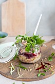 Bulgur with mackerel, beetroot, pea sprouts and dill served in a glass jar