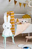 Rabbit lamp on stool in front of cot