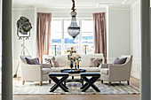 Elegant living room with pale sofa set and chandelier