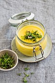 Potato and turmeric cream soup in a glass jar