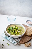 Spring vegetable soup with a piece of bread