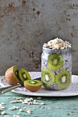 Chia pudding with kiwi and almonds in a glass jar