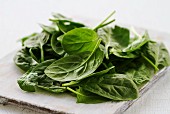Fresh spinach leaves on a chopping board