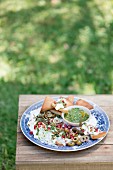 Garlic and lemon labneh with salsa verde and roasted pita bread corners