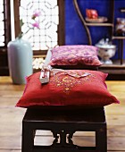 Embroidered cushions on wooden bench