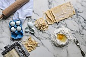Ingredients and kitchen utensils for homemade pasta (top view)