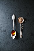 Sesame seed oil and sesame seeds on spoons