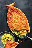 Gourmet fish pie served with turnip and leek in saffron sauce