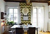 Dining area in front of retro wallpaper in period apartment