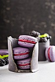 French macarons with berry filling on a gray table