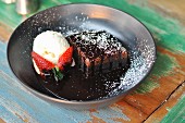 A brownie with chocolate sauce and vanilla ice cream