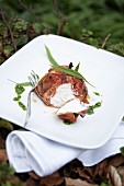 Bacon-wrapped goat's cheese with wild garlic