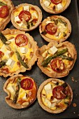Asparagus, tomato, feta and pine nut tarts (seen from above)