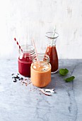 Three different smoothies with blood orange, raspberries, beetroot and tomato