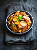 Oven-baked sweet potato slices in a bowl