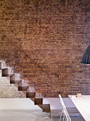 Self-supporting sheet-steel staircase against brick wall
