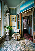 Animal fur and amphora chair with houseplant in vintage ambience with ornamental tiles