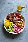 Large bowl with of red quinoa salad with vegetables and chickpeas