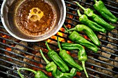Green chilli peppers on a grill