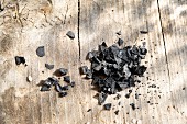 Coarse black salt on a wooden background