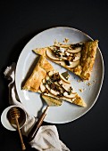 Two slices of puff pastry with pears, goat's cheese and honey (top view)