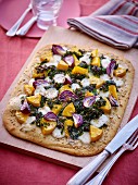 A vegetable pastry with butternut squash, green cabbage and red onions