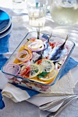Marinated sardines with oranges, lemons and onions in a cream sauce