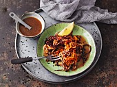 Brightly coloured carrot noodle salad with tahini