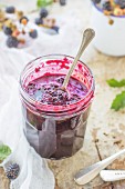 Blackberry jam in a jar with a spoon