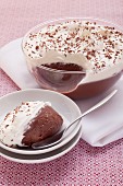 Chocolate pudding with whipped cream and chocolate flakes