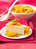 A piece of vanilla and banana cheesecake with peach compote