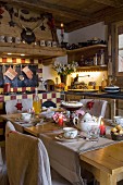 Dining table set with pastries and tea in festive country-house kitchen